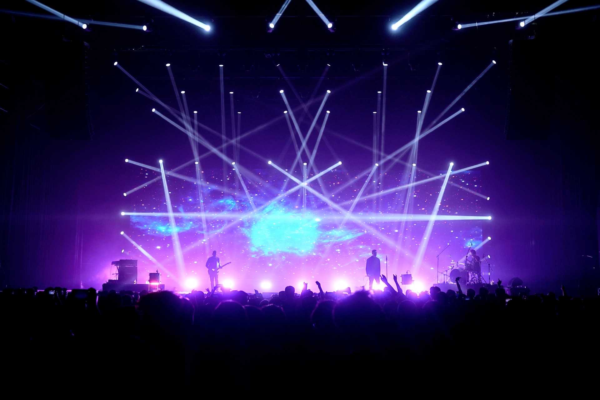 Large festival stage with the band and crowd