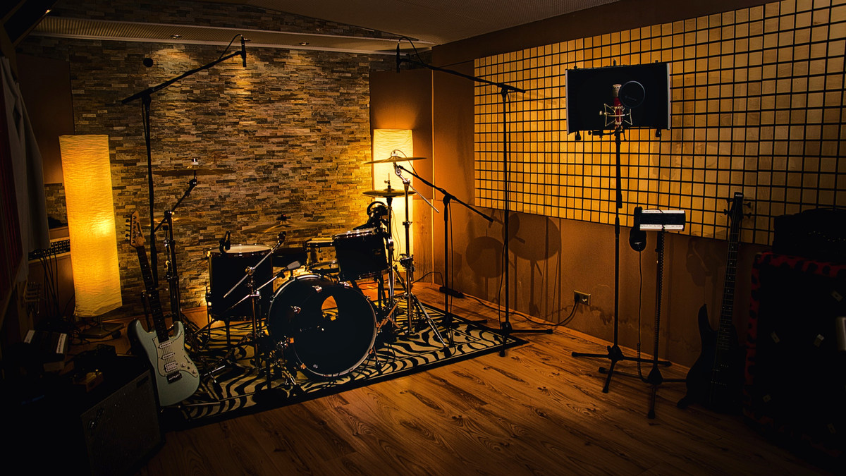 The drum recording room with microphones and acoustic treatment