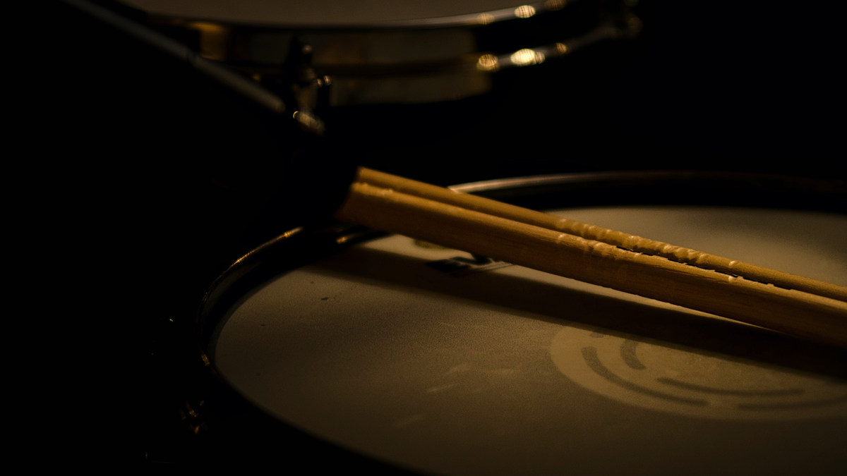 Drumsticks resting on a drum head